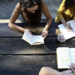 group of young adults reading and writing